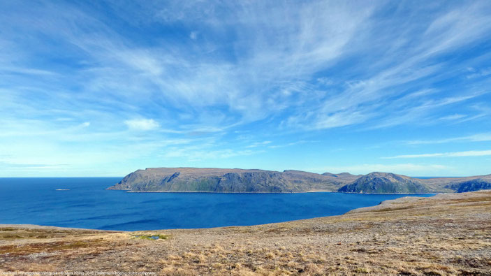 Photo of view to north from Havøygavlen windpark: treeless boreal mountain islands in the Norwegian sea under an open sky