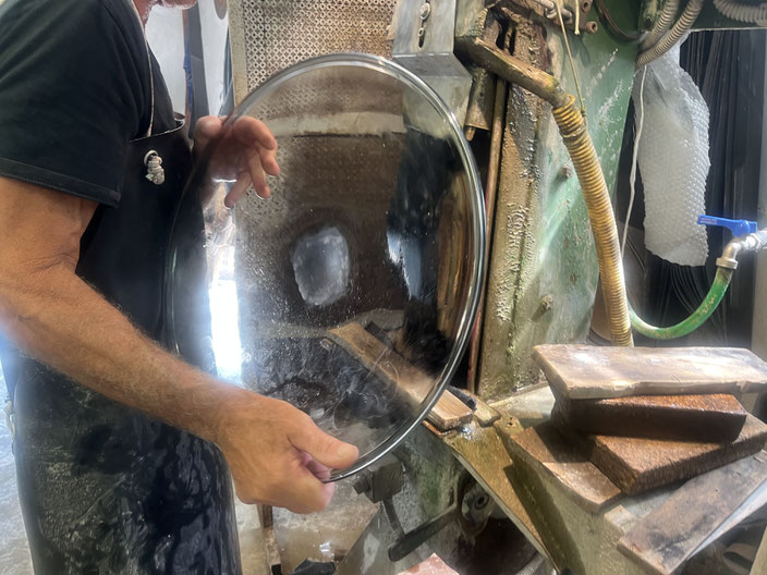 Removing the blowpipe leaves behind excess glass, which must be sanded off later.
