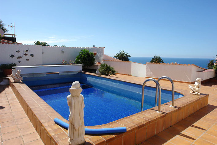 Überdachbarer Pool mit Meerblick in quadratischer Form. 