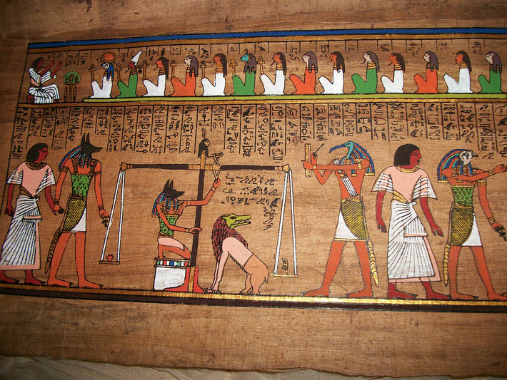 A detailed scene from the Egyptian Book of the Dead shows the Weighing of the Heart ceremony, with Anubis, Thoth, and Ammut, as the deceased's soul is judged against Ma'at's feather of truth.