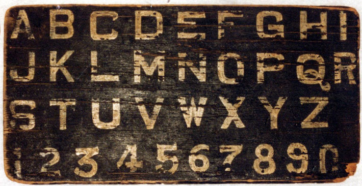 A well worn alphabet board that Meher Baba used.