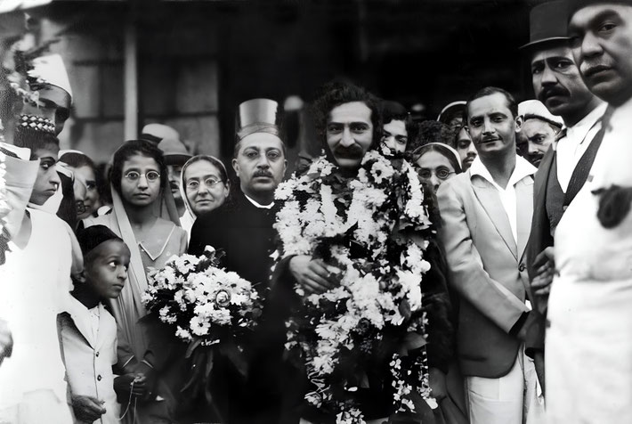 1932 - Meher Baba greeted on his return to Bombay, India. Image enhanced by Anthony Zois.