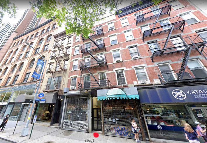 The entrance to her apartment building marked in red.