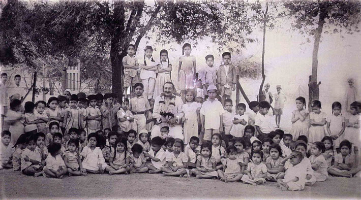 Roshan Kerawalla is standing next to Meher Baba