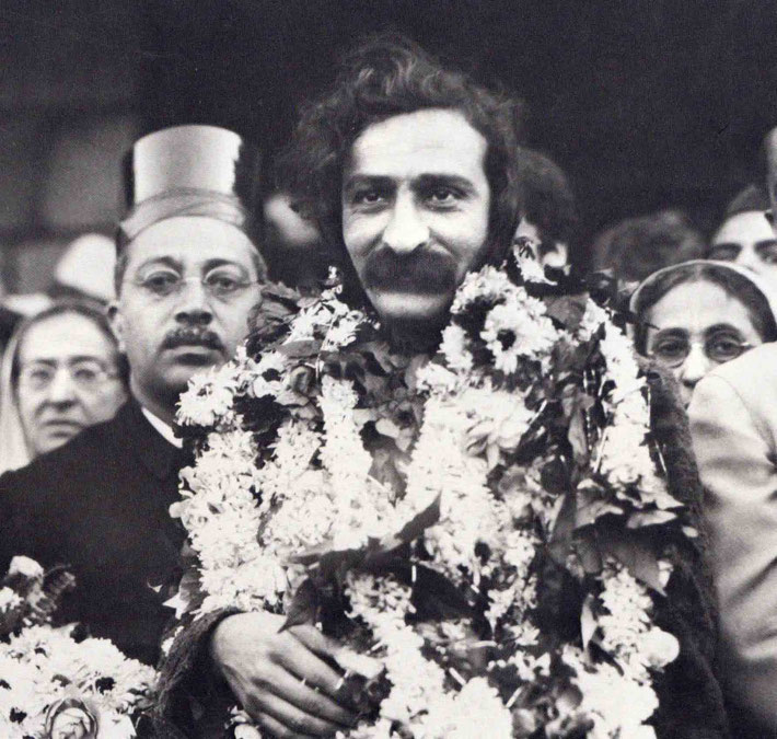1931 - Meher Baba being greeted on his return back to Bombay. His mother Shireen Irani is on his left-rear and Gulmai Irani on his right-rear. Close up of the original photo. See above.