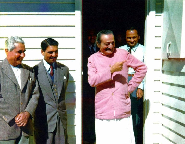 Meher Baba standing in the doorway of Meher House. ( L-R ) Adi K. Irani, Eruch Jessawala, Meher Baba & Dr. Nilu. Photographer- Aubrey Rouse. From the collection of Robert Rouse.