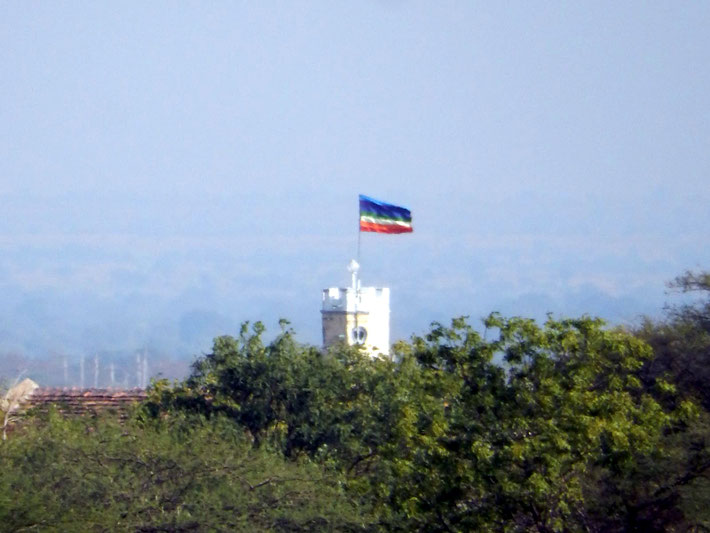 Meher Baba's flag flying at the Tower on Meherabad Hill.