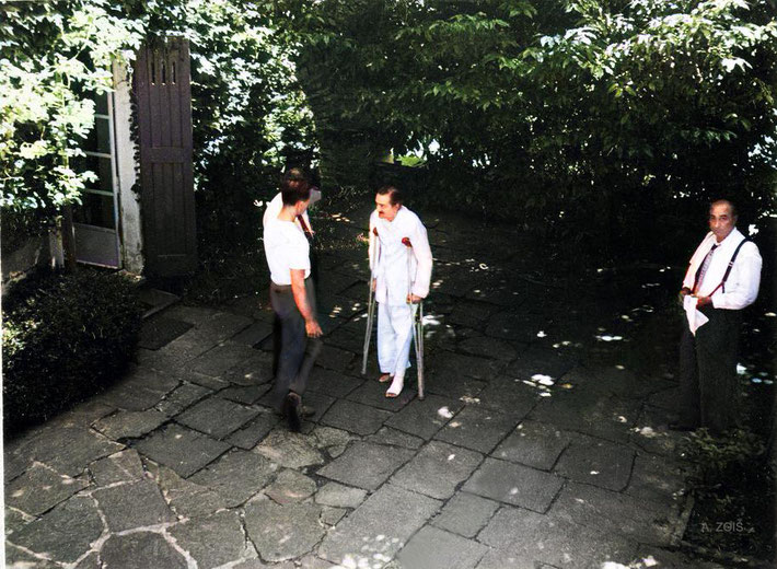 Meher Baba being assisted by Dr. Donkin & Meherjee Karkaria ( hidden ) & Sarosh Irani ( far right ). Image colourization by Anthony Zois.