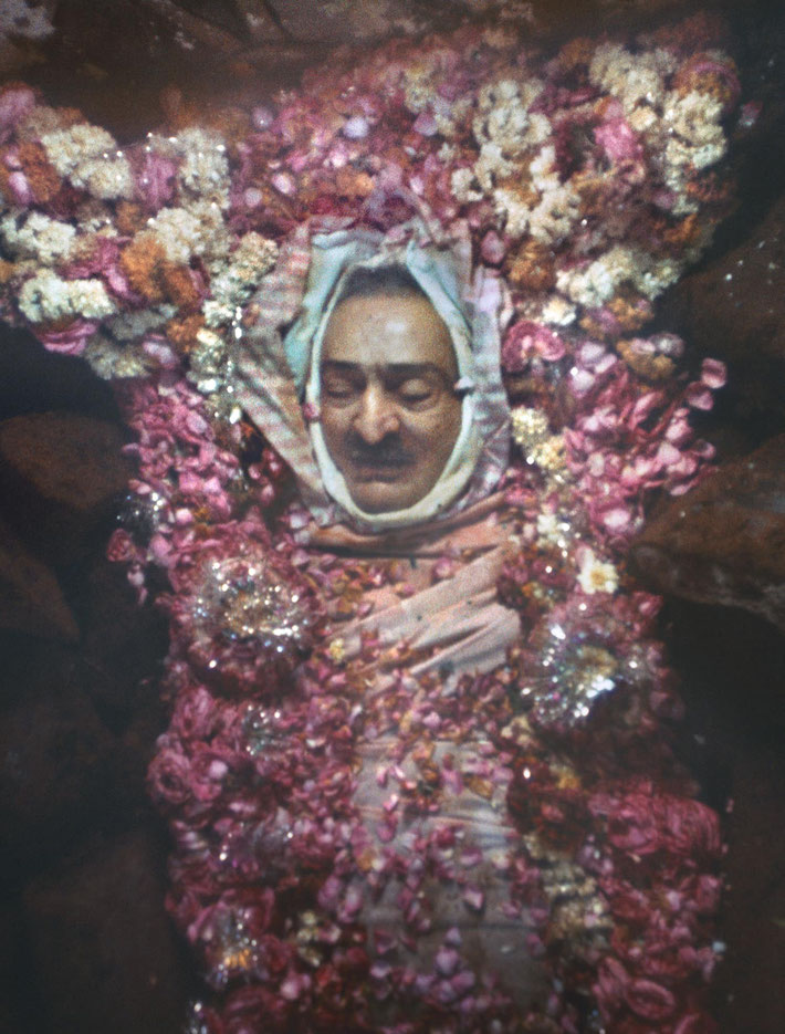 Meher Baba placed in His tomb and viewed for 7 days surrounded by flowers and ice.