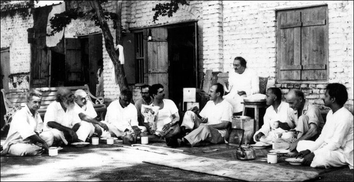 Harry seated at the feet of Baba.