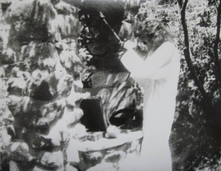 Meher Baba pulling the bucket at the well at Harmon