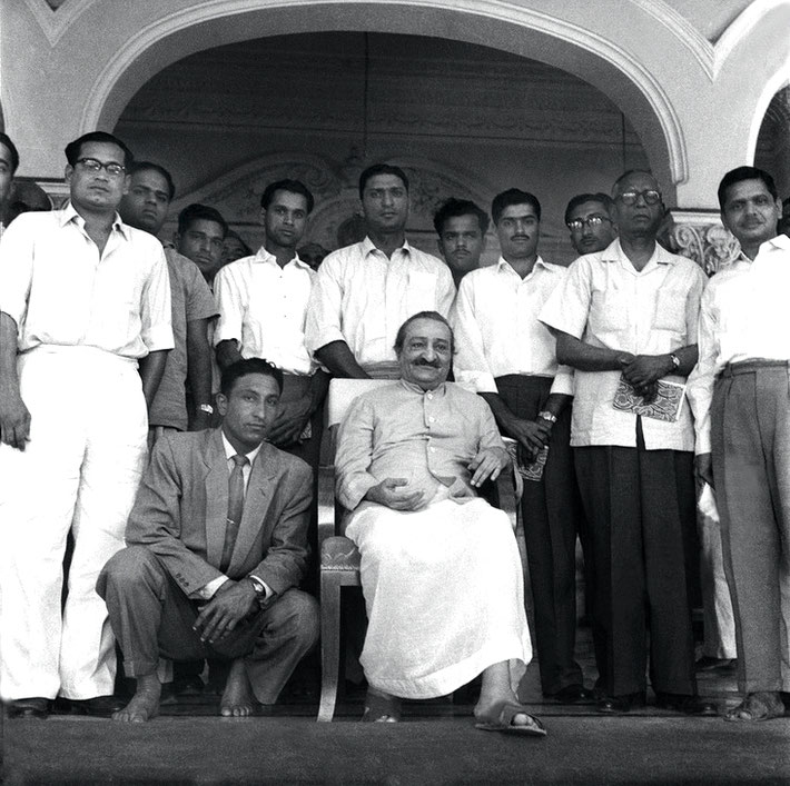 2nd April 1959 - Guruprasad, Poona, India, the Indian Cricket team posing with Meher Baba, some are holding copies of Baba's book "Life at its Best". Polly is standing behind Baba. Photo taken by Meelan