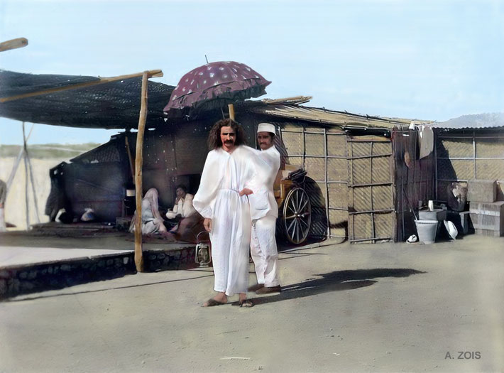 80.  1925 : Meher Baba at Meherabad, India. Nusserwan Satha is holding the umbrella to shield the sun.