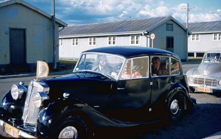 Meher Baba having arrived in Sydney he is seated in the front with Bill Le Page driving and Francis Brabazon in the rear. John Grant is driving the luggage.