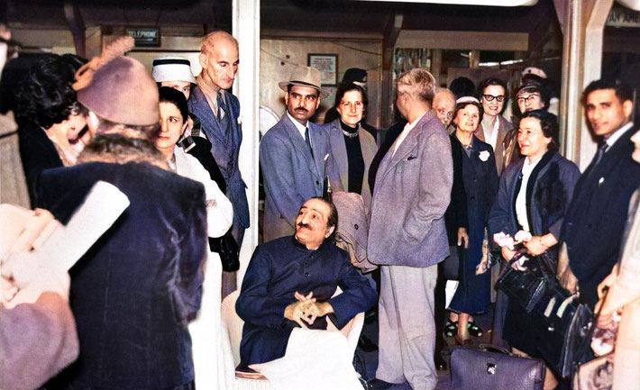 1956 : London Airport - Meher Baba with his men Mandali waiting to get the contecting plane to go to New York. The English Meher Baba group came to be with Baba whilst he waited. Image colourized by Anthony Zois.