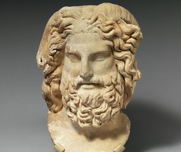 Roman marble head depicting Zeus with ram’s horns, merging Greek and Egyptian deity traits.