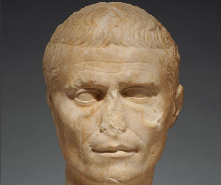 This marble head likely was made to be part of a full statue. The facial features match known portraits of Julius Caesar and the finish is rough on the sides and back, indicating it was meant to be viewed from the front.