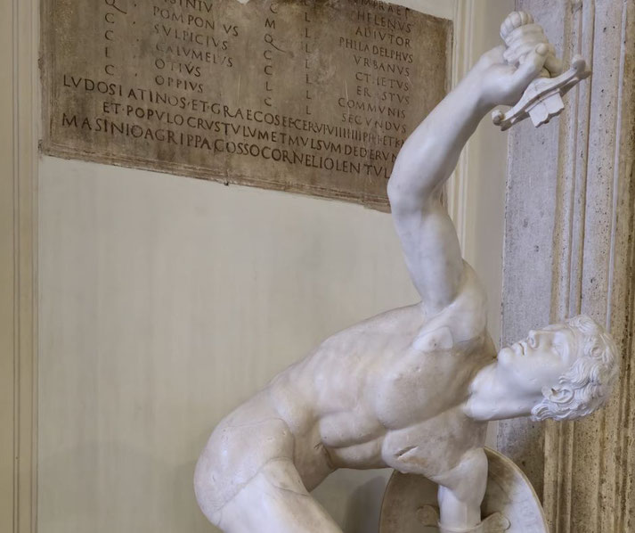 Dramatic marble statue of a wounded warrior collapsing with shield in hand, arm raised holding an object.