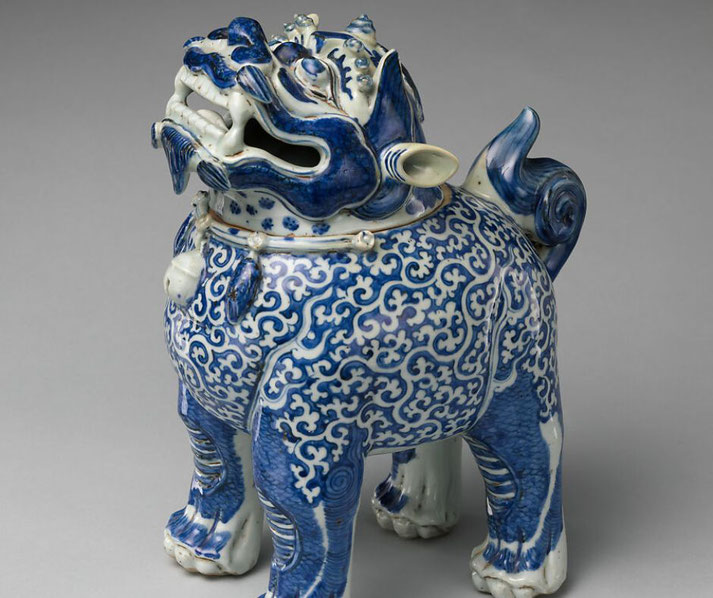 A blue and white porcelain censer shaped like a mythical beast, adorned with intricate swirling patterns.