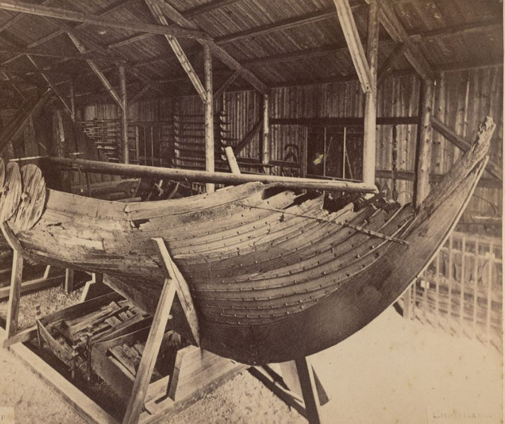 Photograph of a Viking ship in Christiania, Norway, highlighting its detailed wooden construction and historical significance.