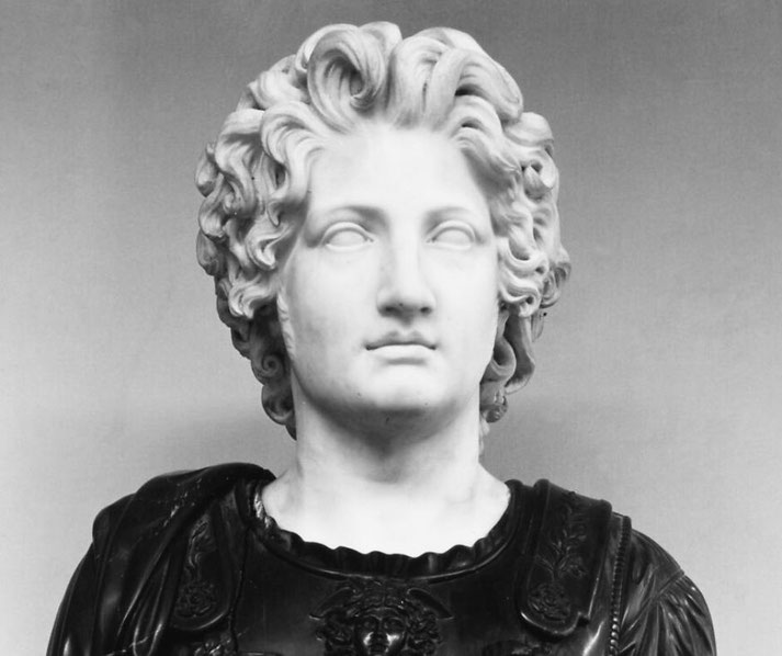 A marble bust of Alexander the Great, depicting his iconic wavy hair and idealized features, symbolizing his status as a legendary conqueror and ruler of the ancient world.