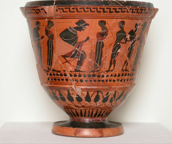 An ancient Greek pyxis, a container for personal objects, decorated with black-figure artwork.