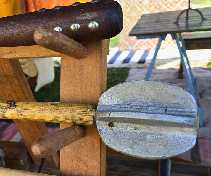 A close-up of medieval-style weapons, including a wooden club with metal studs and a bamboo-handled flanged mace.