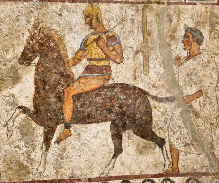Ancient fresco shows a helmeted warrior on horseback holding a spear, followed by a robed man walking behind.