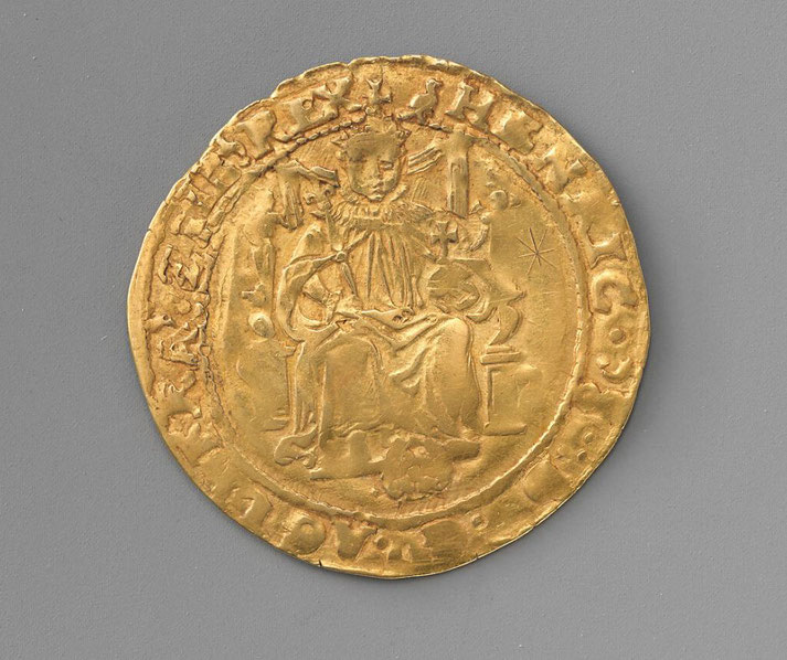 An ancient gold coin featuring a crowned figure seated on a throne, holding a scepter and an orb.