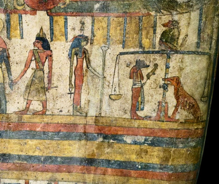Scene from an Egyptian sarcophagus showing the weighing of the heart scene from the book of the dead with Ammit in the bottom right.