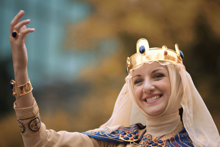 Medieval queen waving and smiling