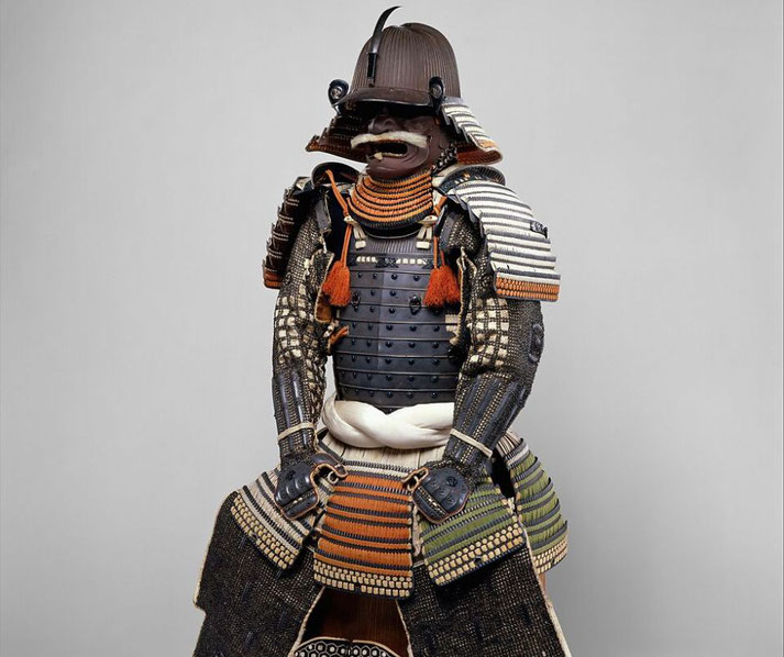A traditional Japanese samurai armor set featuring a dark, ornate cuirass, layered plates, and a fierce menpō (face mask) with a mustache. 