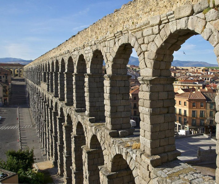 The ancient Roman aqueduct of Segovia, Spain. Built of unmortared granite blocks, its towering arches stretch across the city.