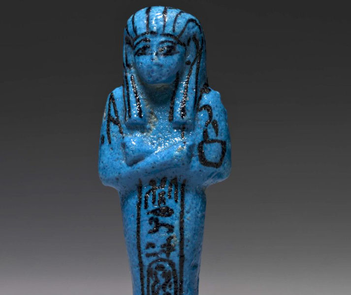 Bright blue faience figurine with king's name in cartouche, intended to serve the deceased in the afterlife.