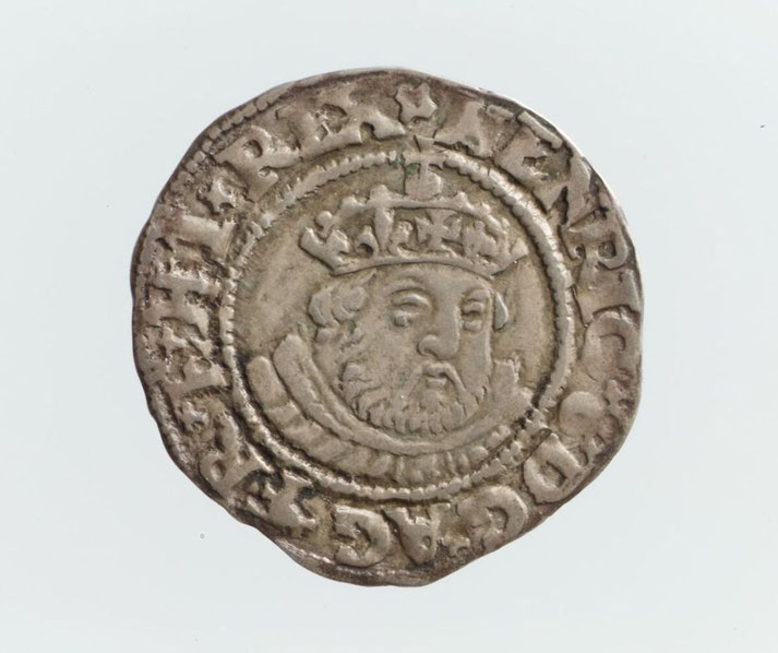 An old silver coin featuring a bearded king wearing a crown, surrounded by Latin inscriptions.