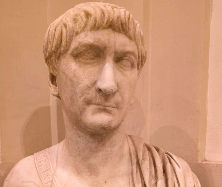 Marble bust of a Roman man with short, straight hair and a serious expression, wearing a toga with a decorative border.