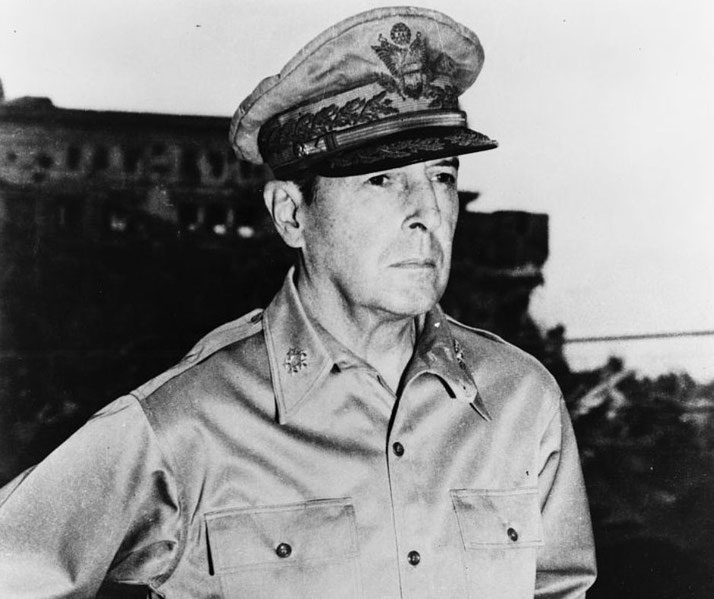 A senior military officer in uniform stands with a stern expression, captured in a black-and-white World War II era photo.