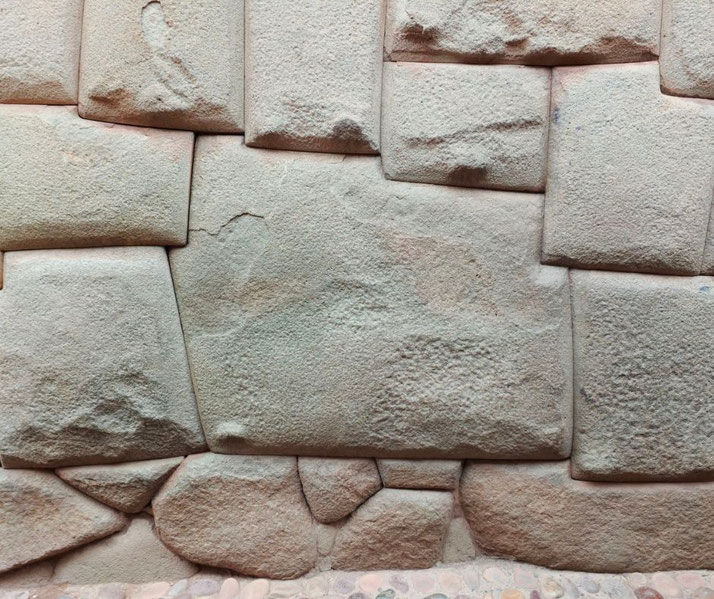 The famous Twelve-Angle Stone in Cusco, Peru. It is an example of precise Inca masonry, fitting seamlessly with surrounding stones without mortar.