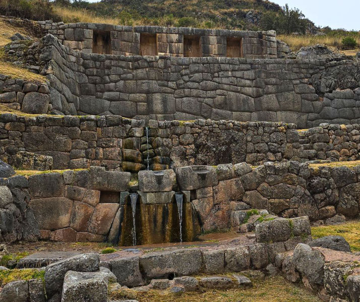 Tambomachay, an ancient Incan site near Cusco, Peru. It features finely crafted stonework with cascading water fountains, believed to have been used for ceremonial or ritualistic purposes.