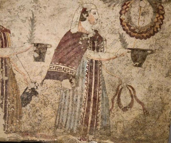 Ancient fresco of a woman in ornate clothing holding ritual vessels and a palm frond, facing a wreath, possibly in a ceremonial or offering scene.
