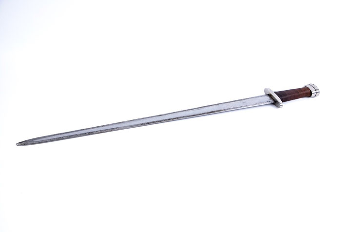 A sword with a straight, double-edged blade, a wooden grip, and a distinctive pommel.