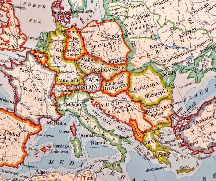 Old printed political map of Central and Eastern Europe with country borders highlighted in red and yellow, showing cities and regions across Germany, Poland, Czechoslovakia, Hungary, and surrounding nations.