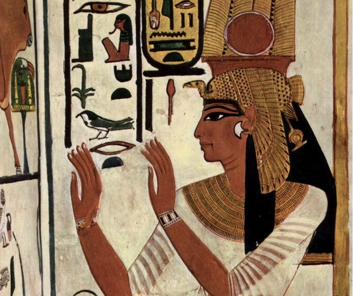 Ancient Egyptian wall painting of a queen or goddess in profile, wearing a tall headdress and white gown, with hieroglyphs surrounding her.