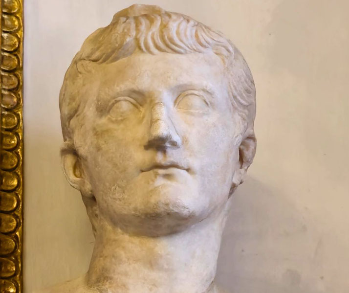 Marble bust of a young man with short, neatly styled hair and smooth features.