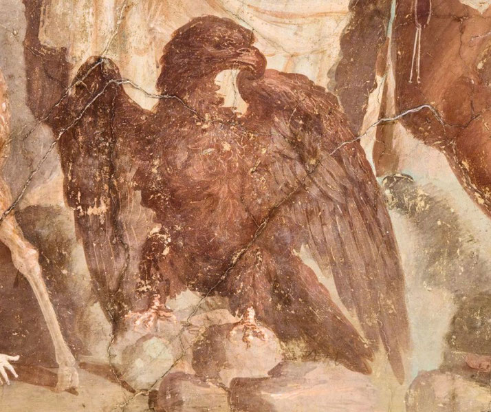 Ancient fresco of a powerful eagle with wings spread, perched on rocky ground, depicted in rich brown tones with detailed feathers.