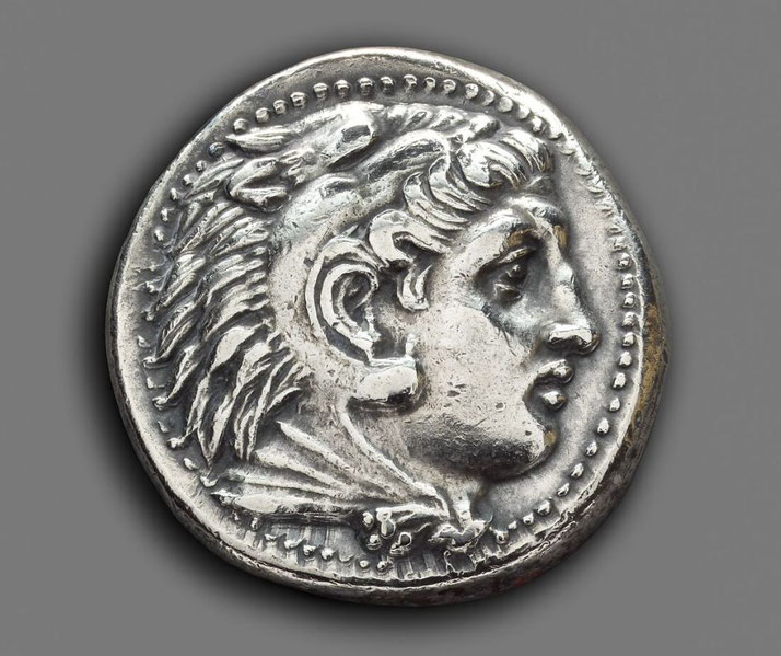 Greek silver coin depicting Herakles on the obverse and Zeus seated on the reverse, minted in Pella.