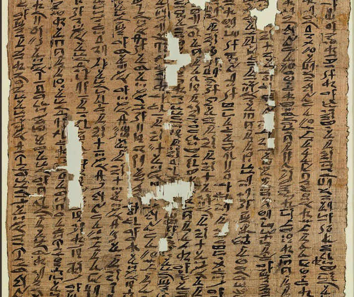 An ancient Egyptian papyrus with black hieratic script, likely a letter or document. The worn and fragmented state reveals missing sections, but the text remains mostly legible.