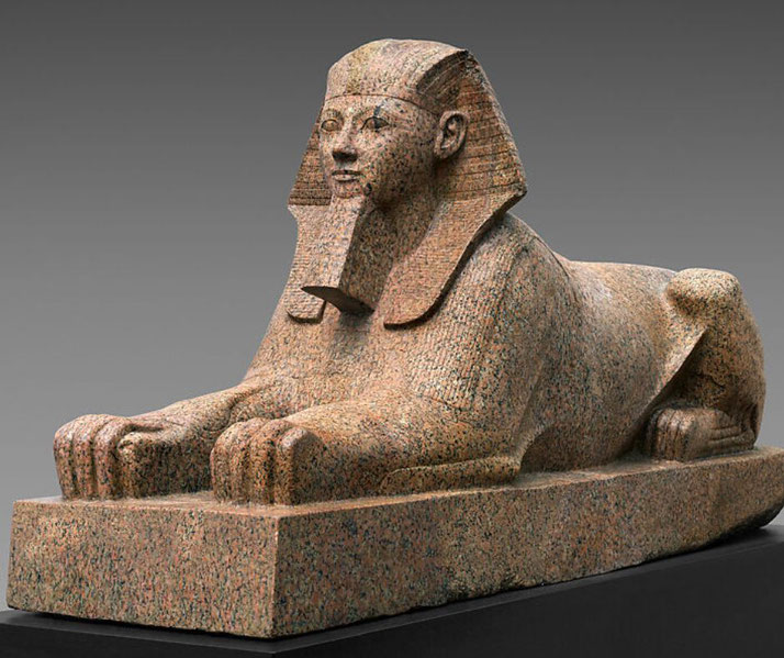 Granite sphinx of Hatshepsut with lion's body and human head, wearing nemes headcloth and false beard.