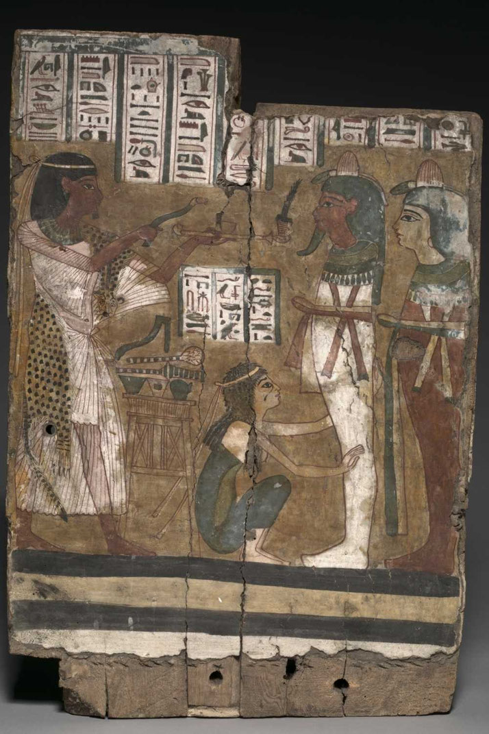 An ancient Egyptian painted wooden panel showing a priest performing a ritual. Hieroglyphs surround figures, including a kneeling woman and deities with green and red skin, in vibrant colors.