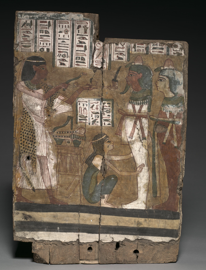 An ancient Egyptian painted wooden panel showing a priest performing a ritual. Hieroglyphs surround figures, including a kneeling woman and deities with green and red skin, in vibrant colors.
